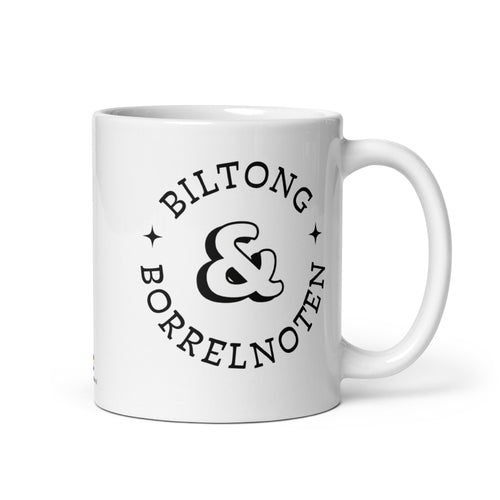 White glossy ceramic mug with black typographic design reading “Biltong & Borrelnoten,” funny South African and Dutch crossover mug.