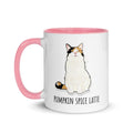White ceramic mug with pink rim and handle featuring fluffy calico cat Lina Love sitting contentedly above the text “Pumpkin Spice Latte, Extra Foam.”