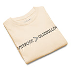 Natural kids t-shirt with the text “Vetkoek > Oliebollen” printed across the chest, South African Roots youth tee.