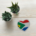Heart-shaped embroidered patch combining South African and Dutch flag colours, Two Homes One Heart South African Roots accessory.