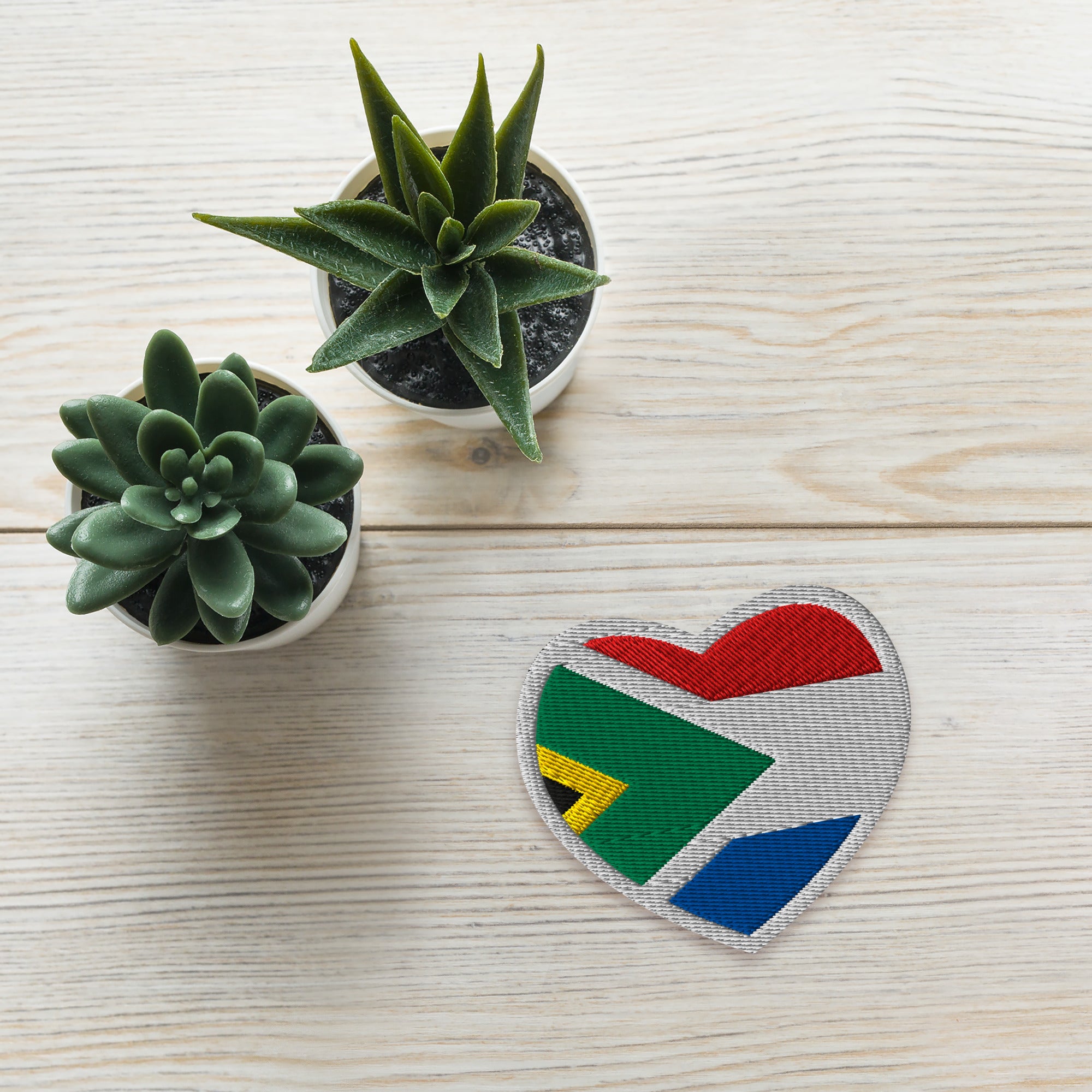 Heart-shaped embroidered patch combining South African and Dutch flag colours, Two Homes One Heart South African Roots accessory.