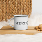 White enamel camping mug with silver rim and wraparound black “Vetkoek > Oliebollen” text, part of the South African Roots collection.