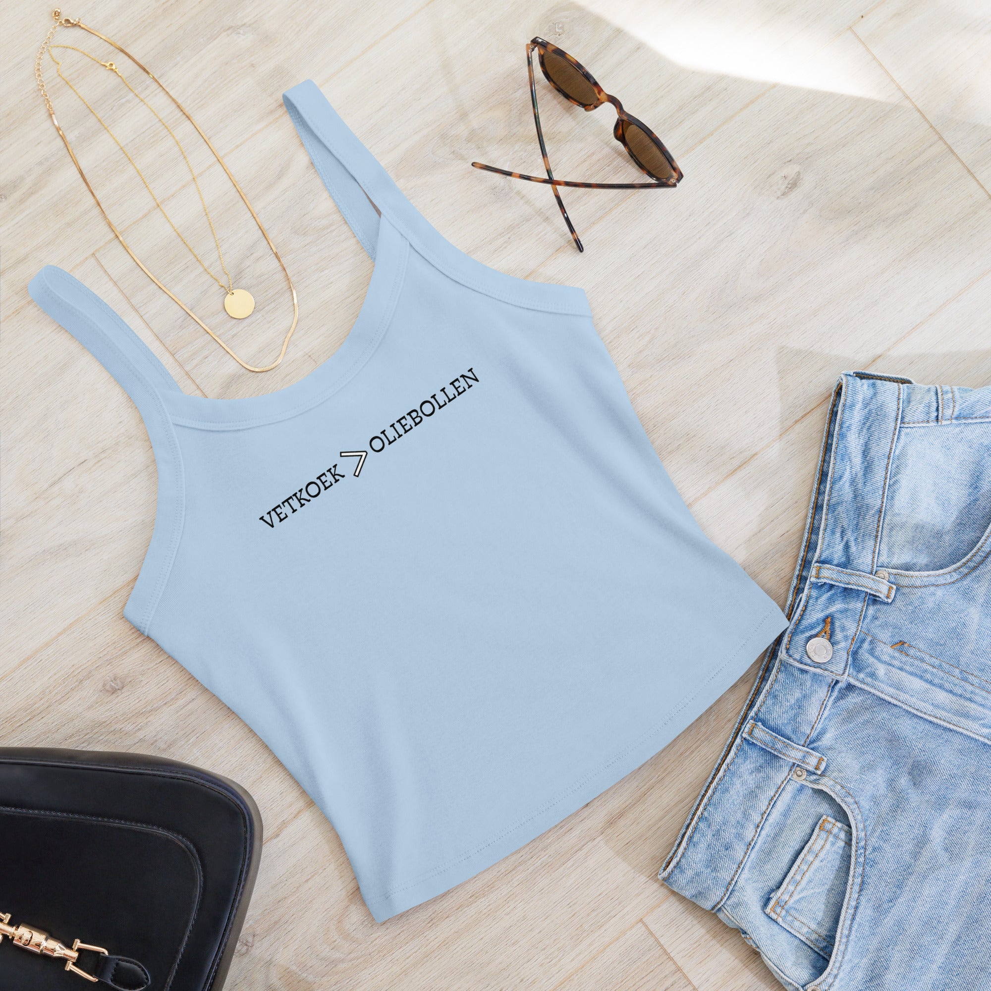 Women’s micro-rib tank top with the text “Vetkoek > Oliebollen” printed across the chest, South African Roots collection top.